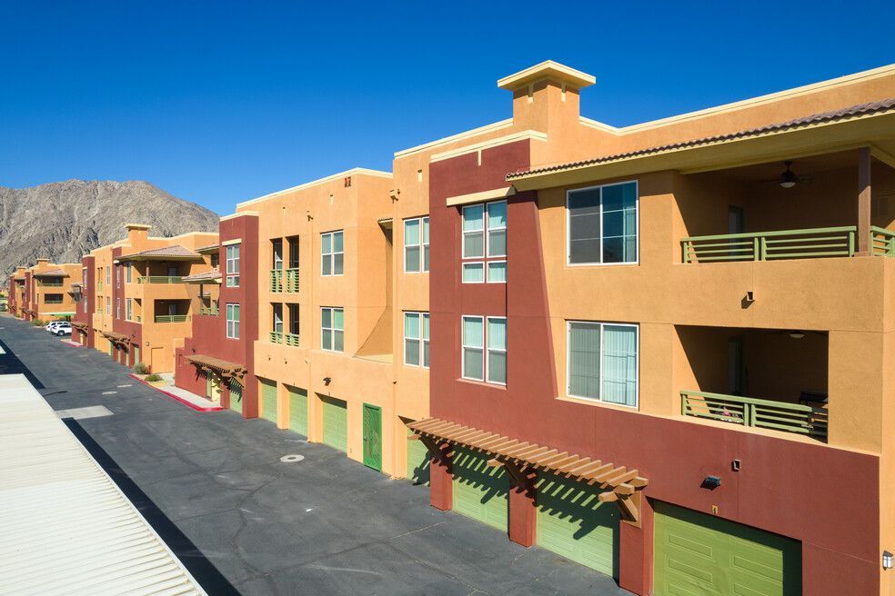 A row of apartment buildings with mountains in the background