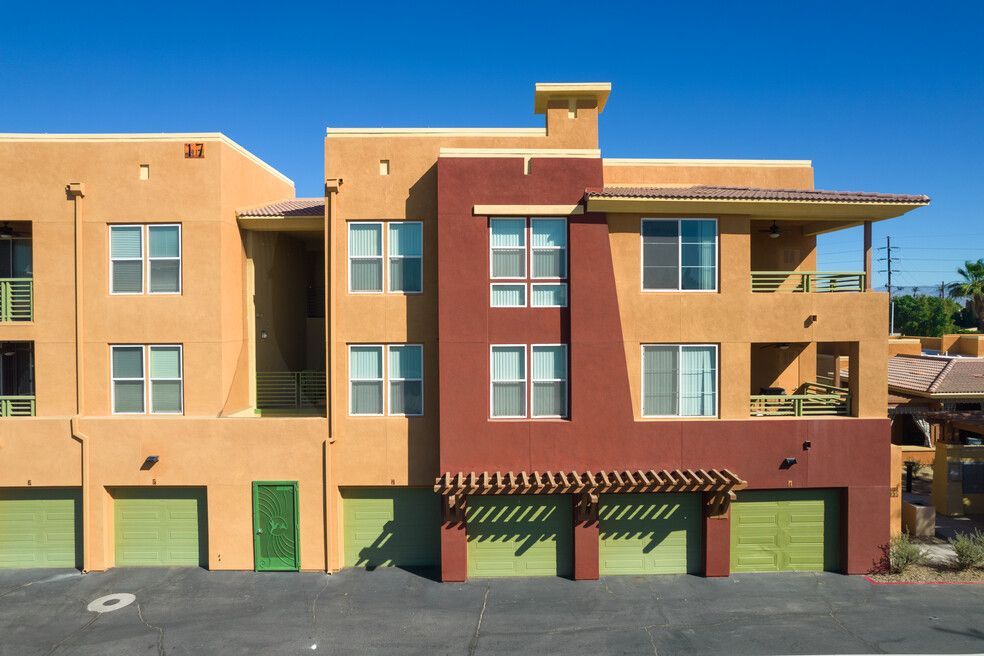 A building with a lot of windows and green garage doors