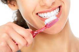 General dentist in Topeka KS near me. Woman brushing teeth after learning about preventative dental care in Topeka KS
