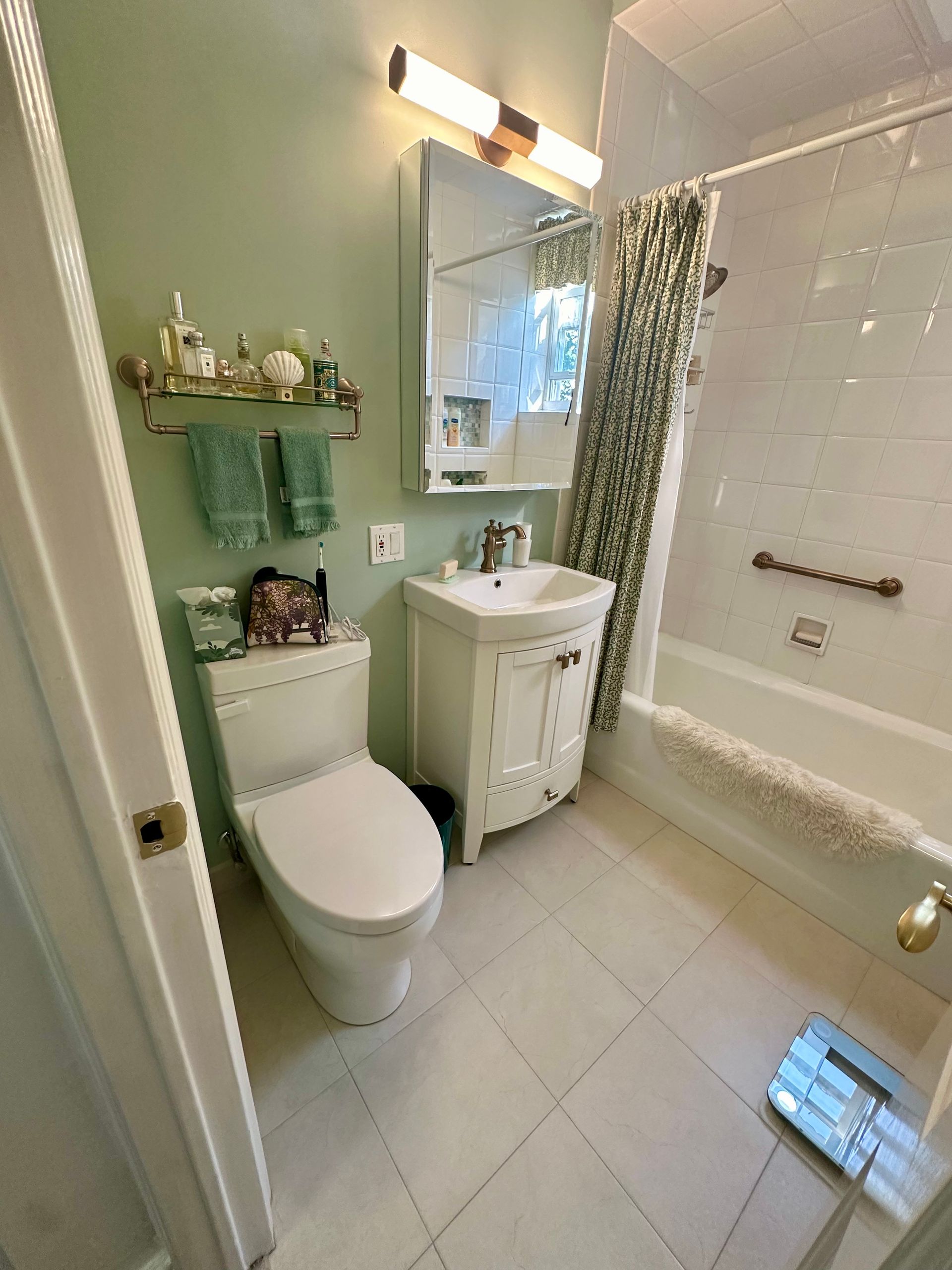 A bathroom with a toilet , sink , and bathtub.