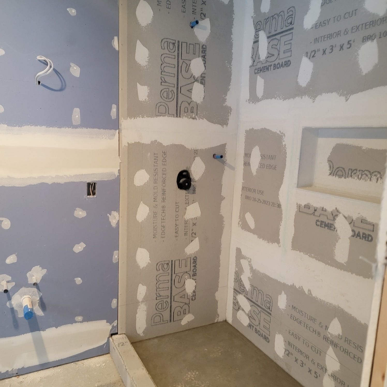A bathroom that is being remodeled with drywall sheets