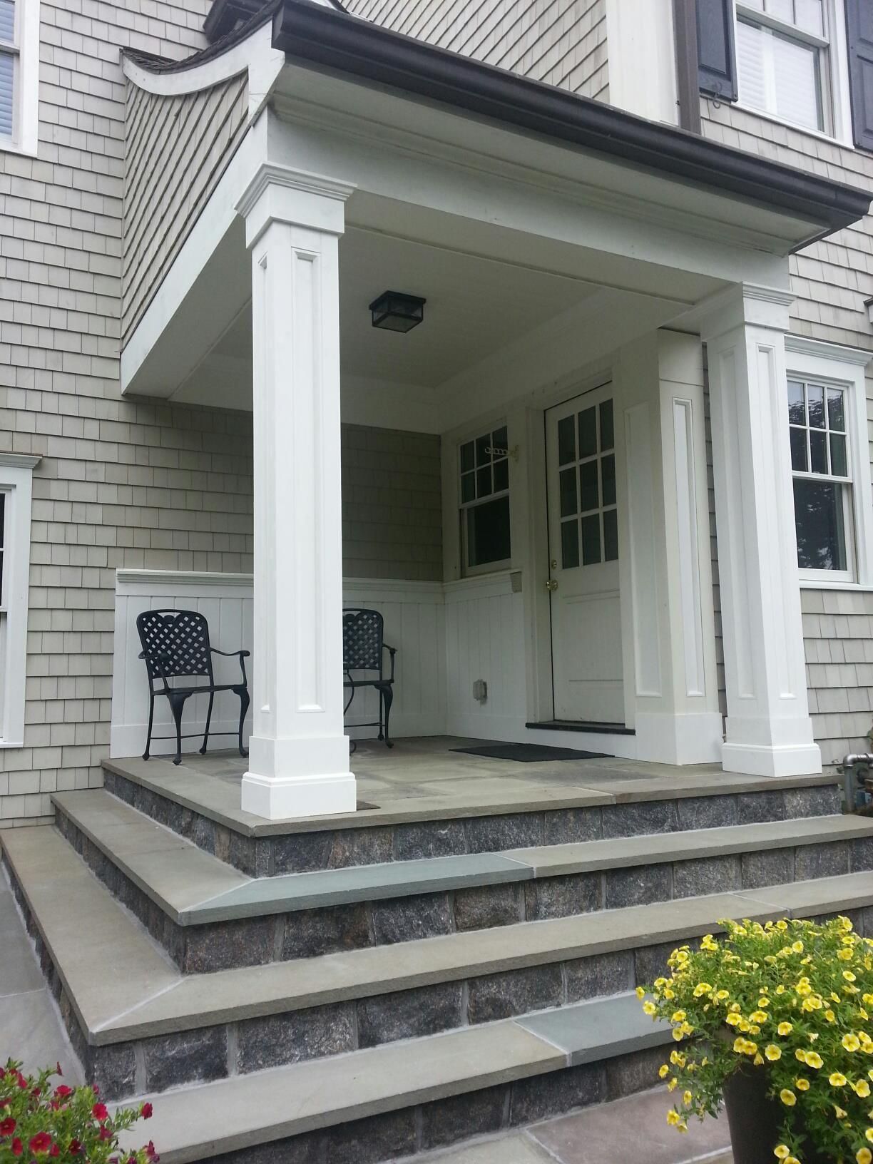 A house with a porch and stairs leading up to it