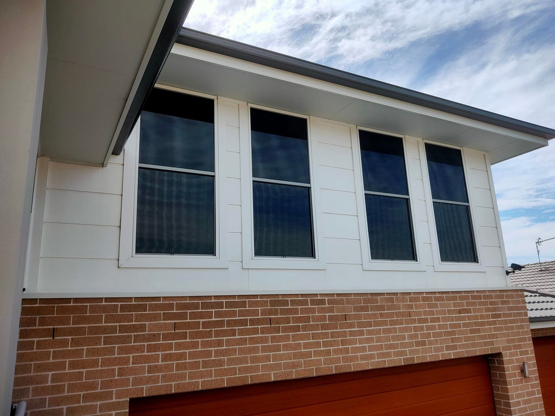 A Building With A Lot Of Tinted Windows โ Sunblitz Window Tinting In Dapto, NSW