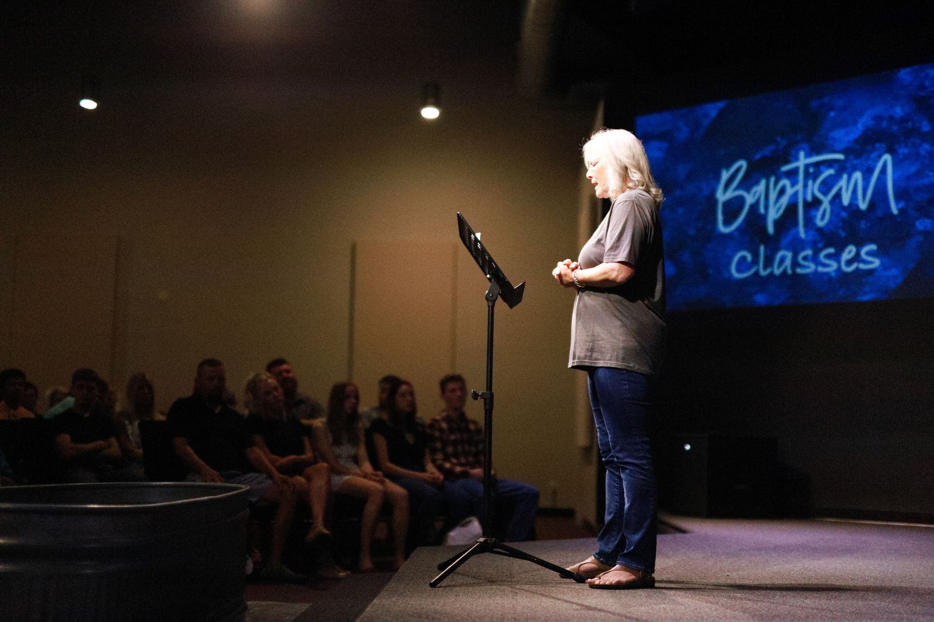 A woman wearing a t-shirt that says i teach tiny humans about jesus