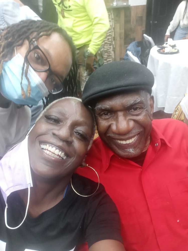 Three person are posing for a picture.