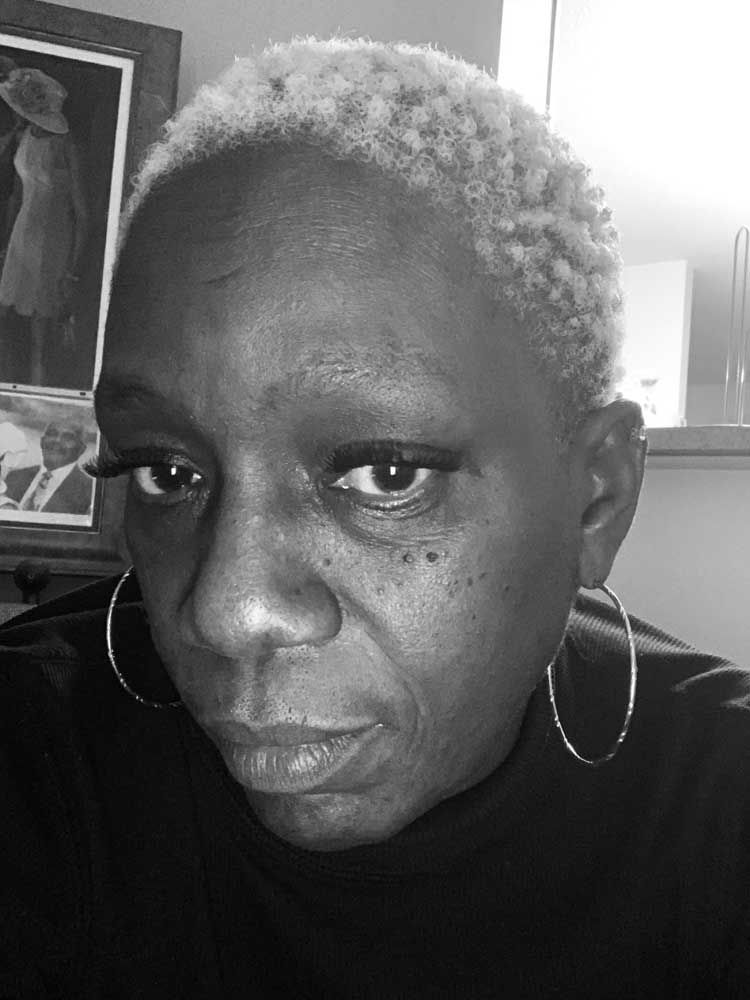 A black and white photo of a woman wearing earrings.