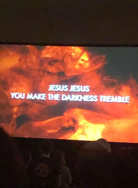 Flaming orange background with white text: “JESUS JESUS YOU MAKE THE DARKNESS TREMBLE.”