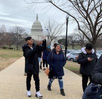 People walking on a path near the U.S. Capitol on a cloudy day