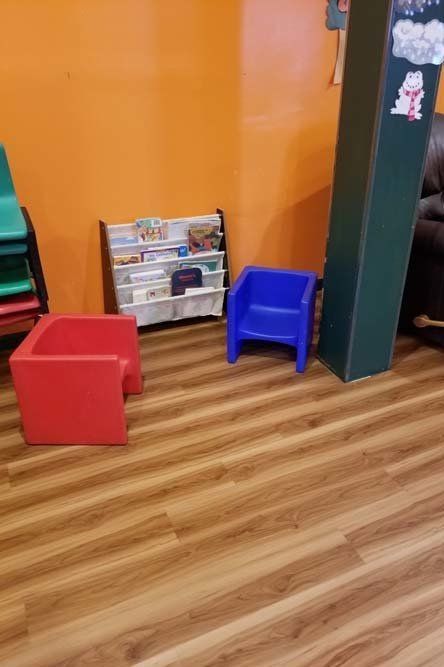 There are two chairs and a bookshelf in the room.