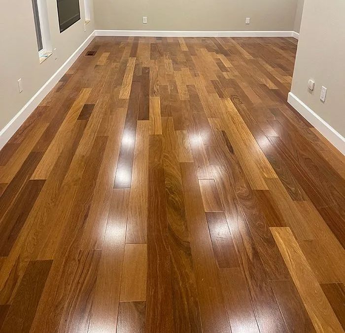 A living room with hardwood floors and white trim.