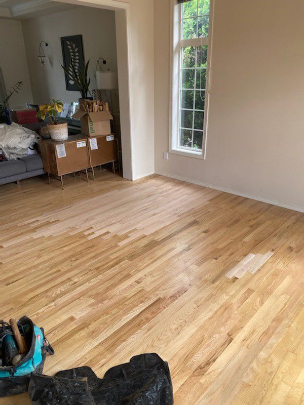 A living room with hardwood floors and a couch.