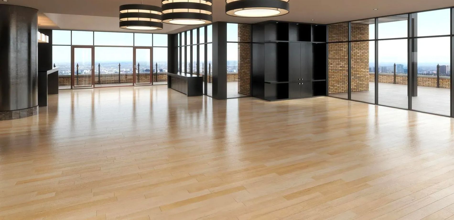 An empty room with wooden floors and lots of windows