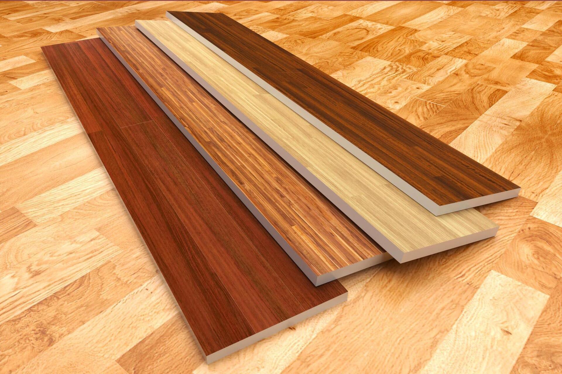 Four pieces of wood are stacked on top of each other on a wooden floor.