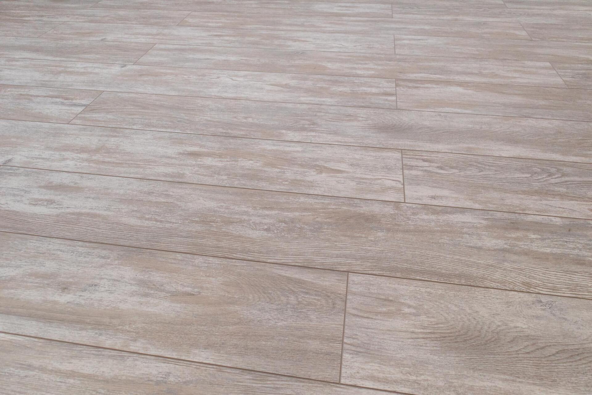 A close up of a wooden floor with a grainy texture.