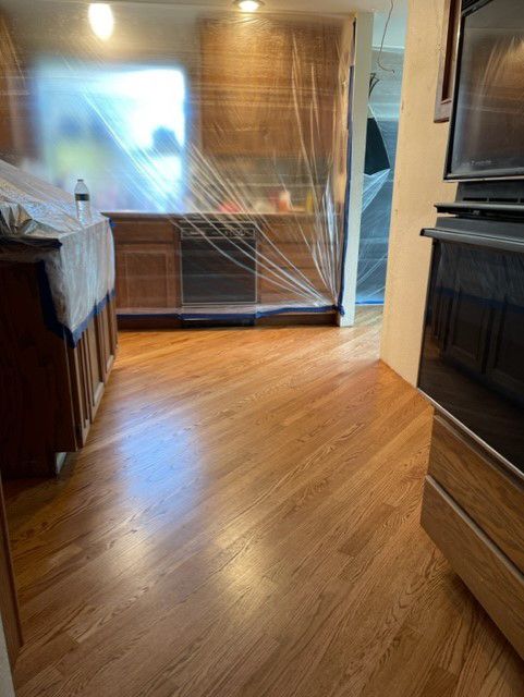 A kitchen with hardwood floors and a stove.