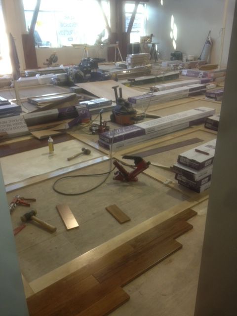 A room with a lot of wood and tools on the floor