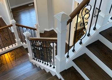 A staircase with wooden steps and a white railing