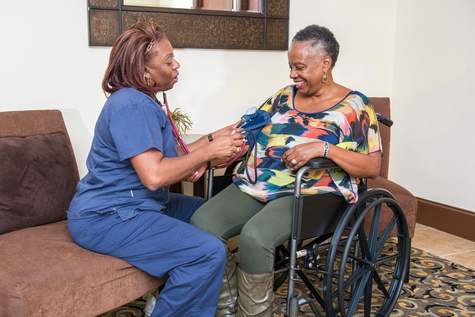 A nurse is helping an elderly woman in a wheelchair.