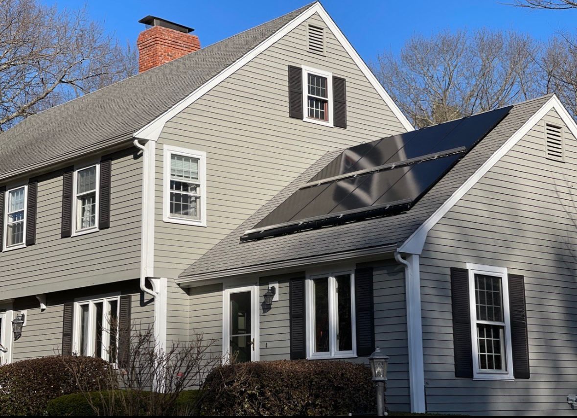 Happy homeowner shaking hands with a Merrimack Solar rep after financing approval