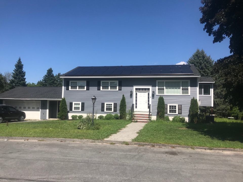 Panoramic view of a solar array installed on a multi-story home