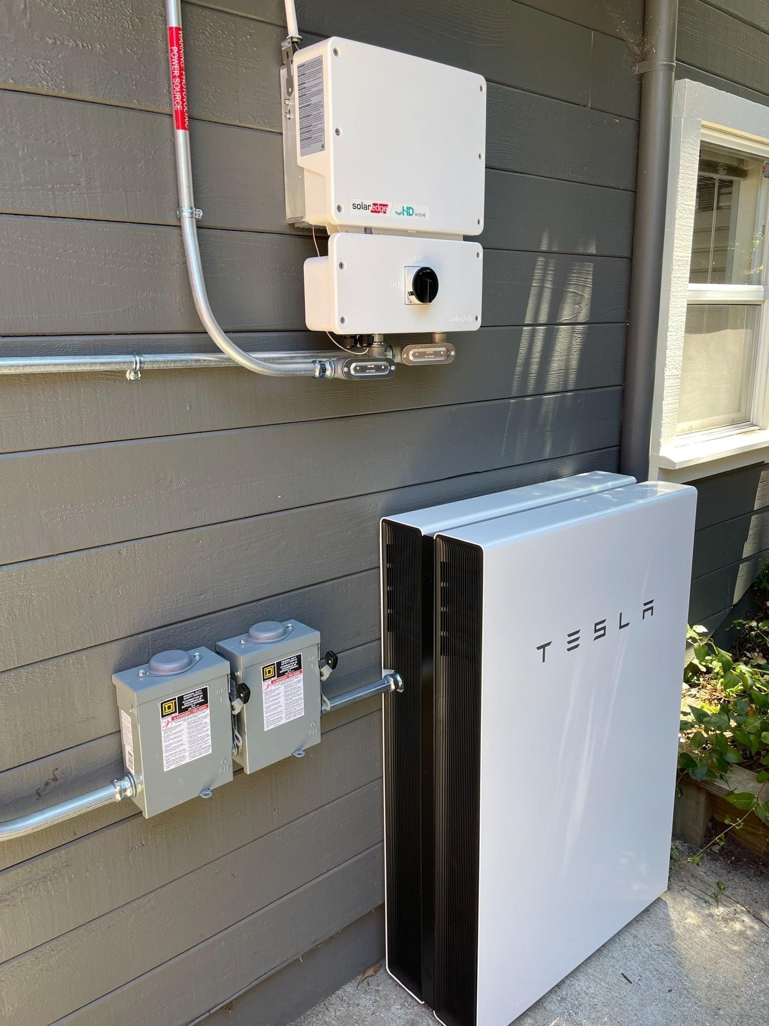 Merrimack Solar technician installing a Tesla Powerwall in Merrimack, NH