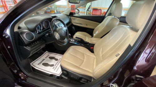 Tan leather interior of a car in EG Automotive detailing facility