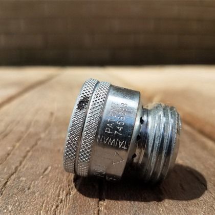 A silver metal hose coupling. 