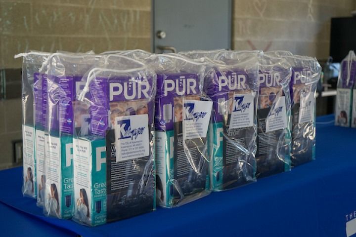 Packaged PUR water filters in clear plastic wrap on a blue table,