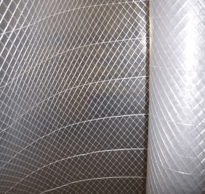 Close-up of gray quilted fabric with a diamond pattern and curved seams, divided by a vertical seam