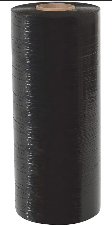 Black plastic-wrapped cylindrical roll with a tan core on top, isolated on white background
