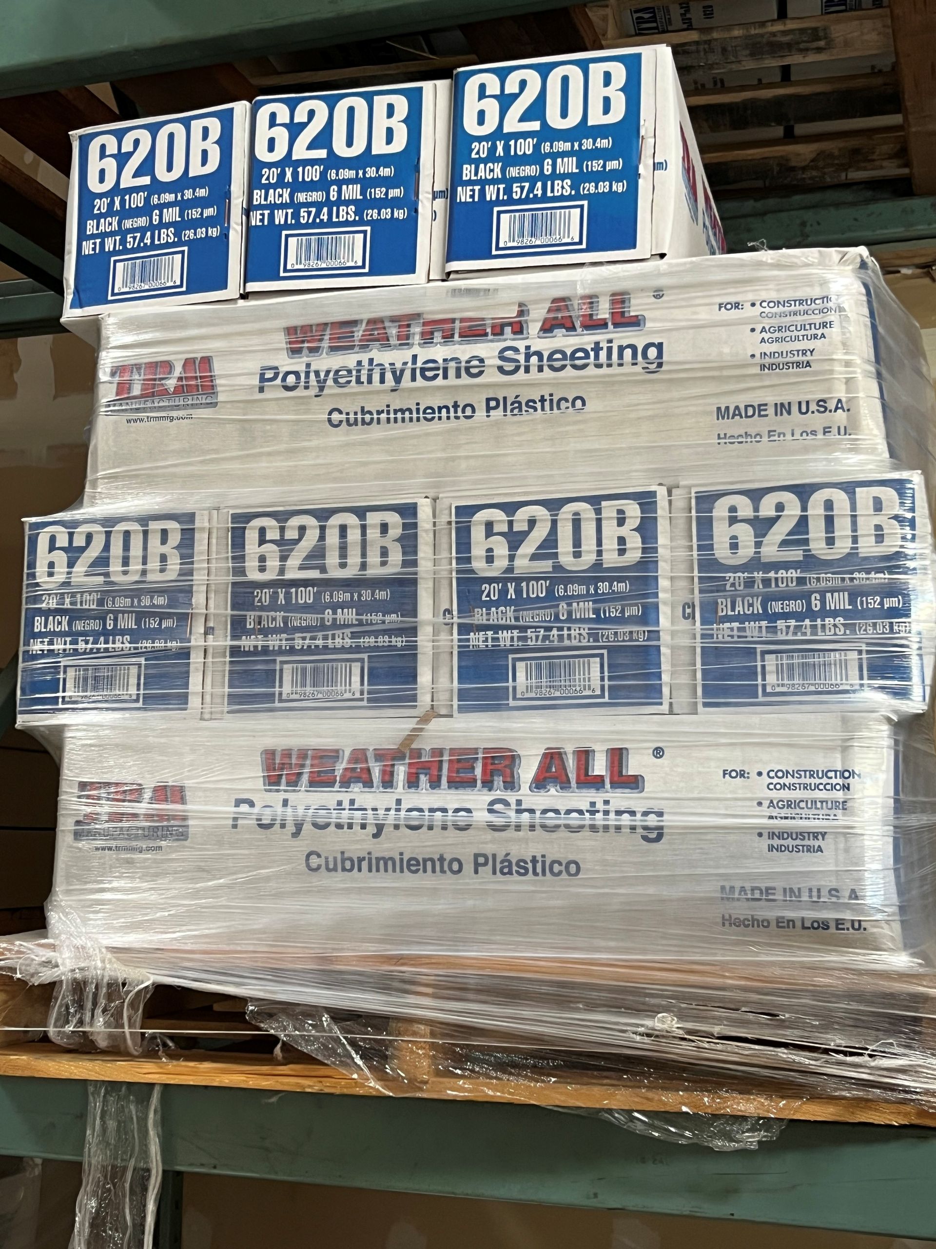 Stacks of white paper rolls on wooden pallets in a warehouse or storage area
