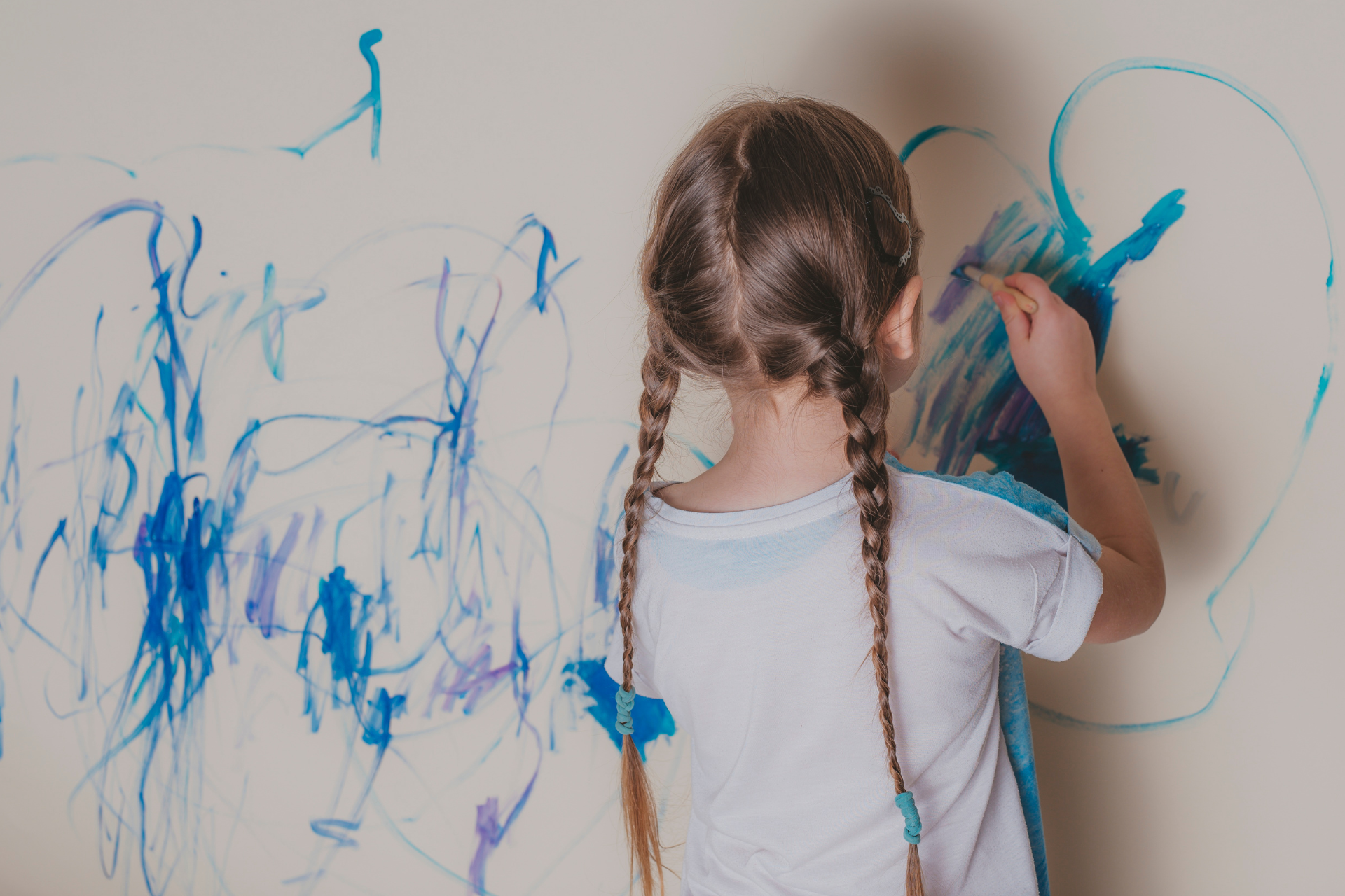 a child coloring a wall