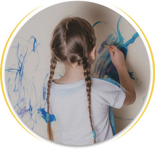 a child coloring a wall