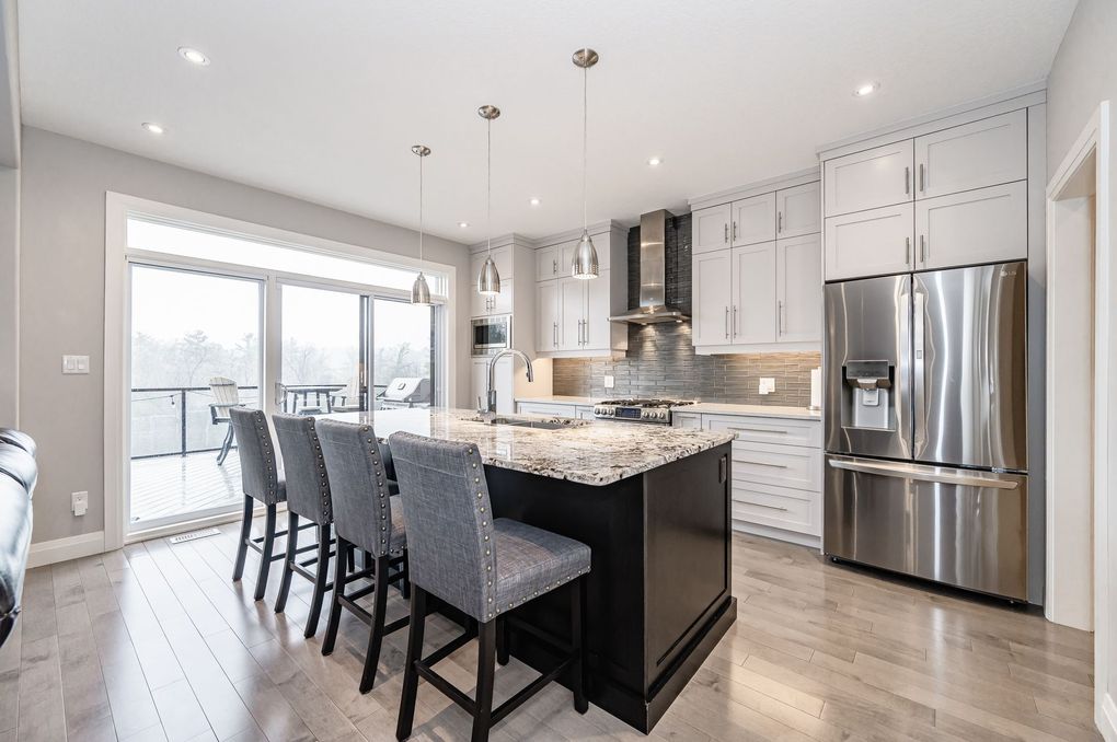 A kitchen with a large island and stainless steel appliances.
