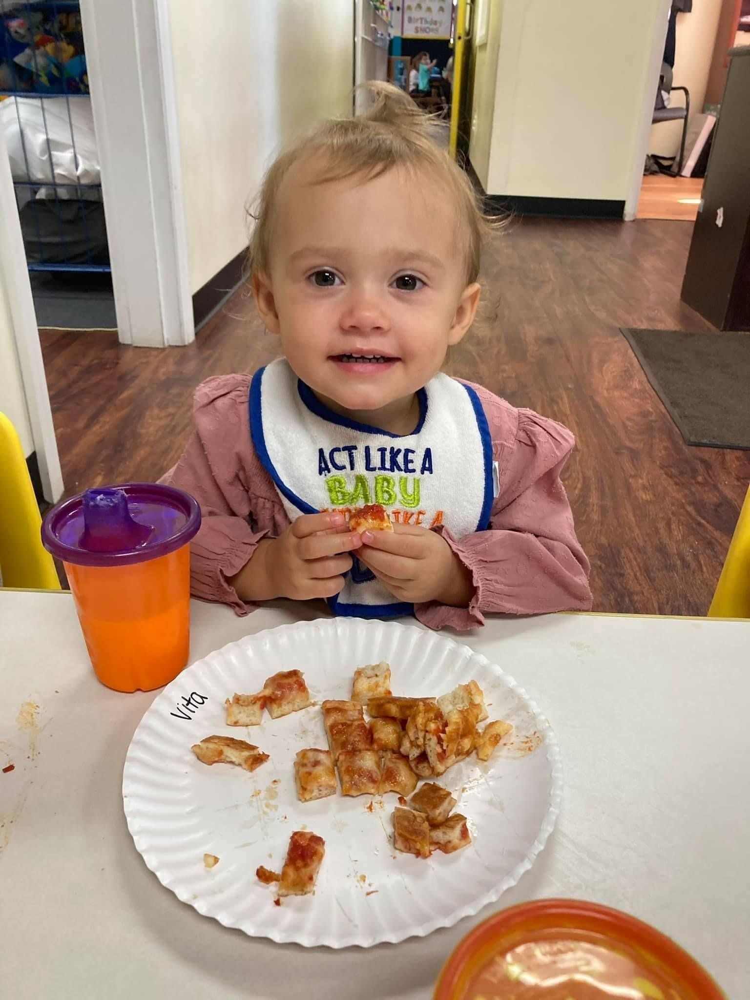 young girl eating snack at school