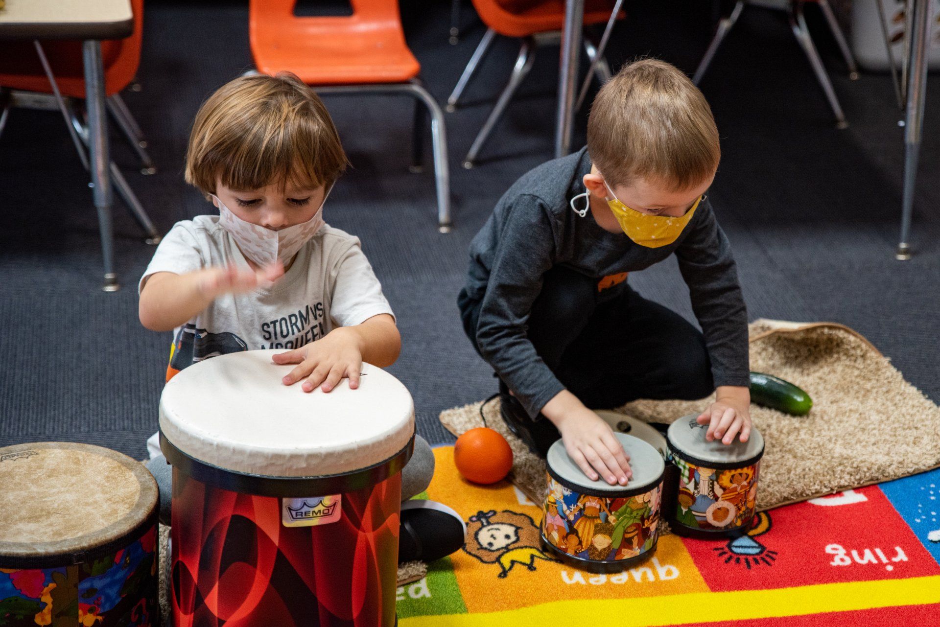 two young boys playing with drums