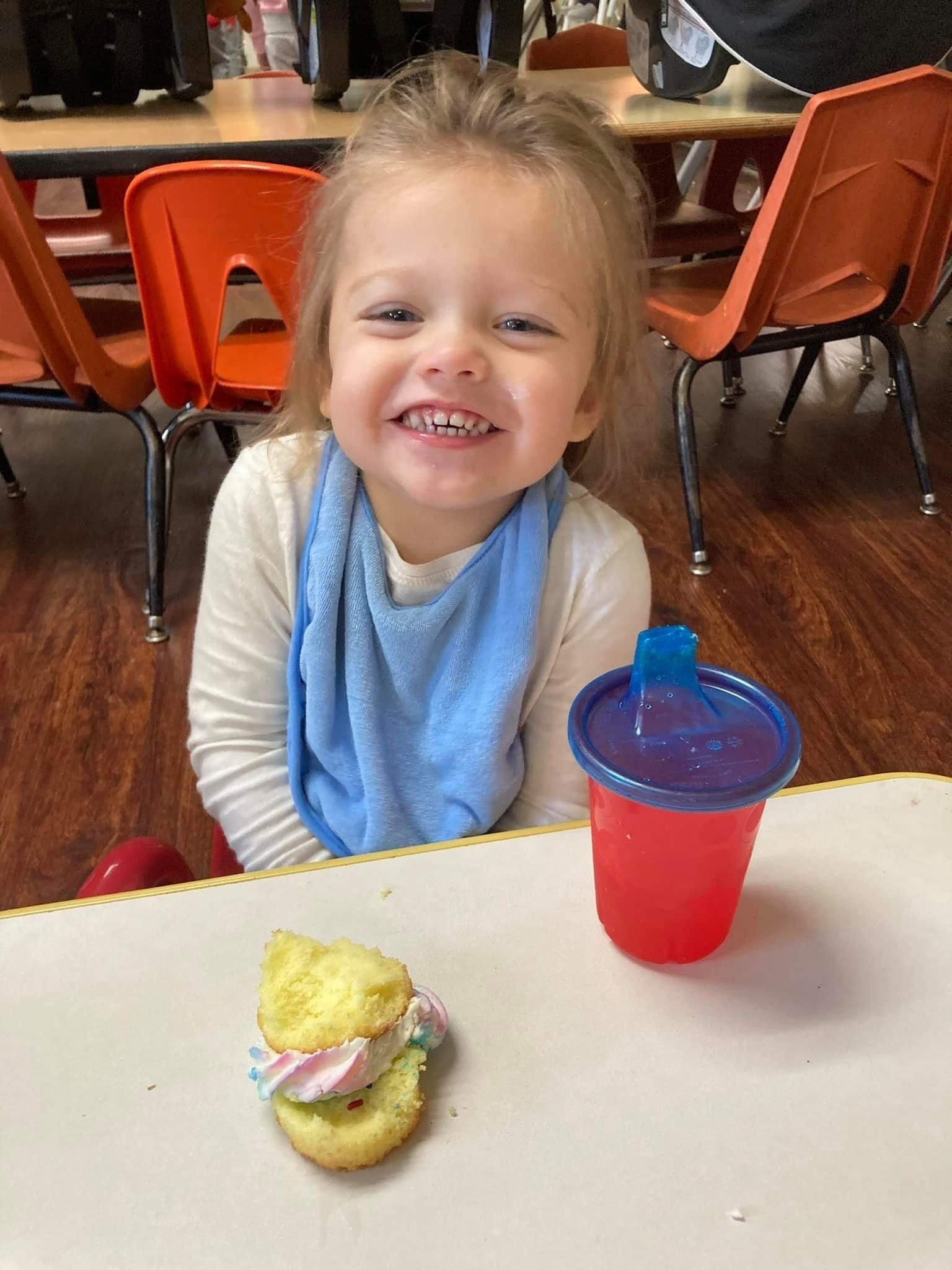 young girl smiling during snack time