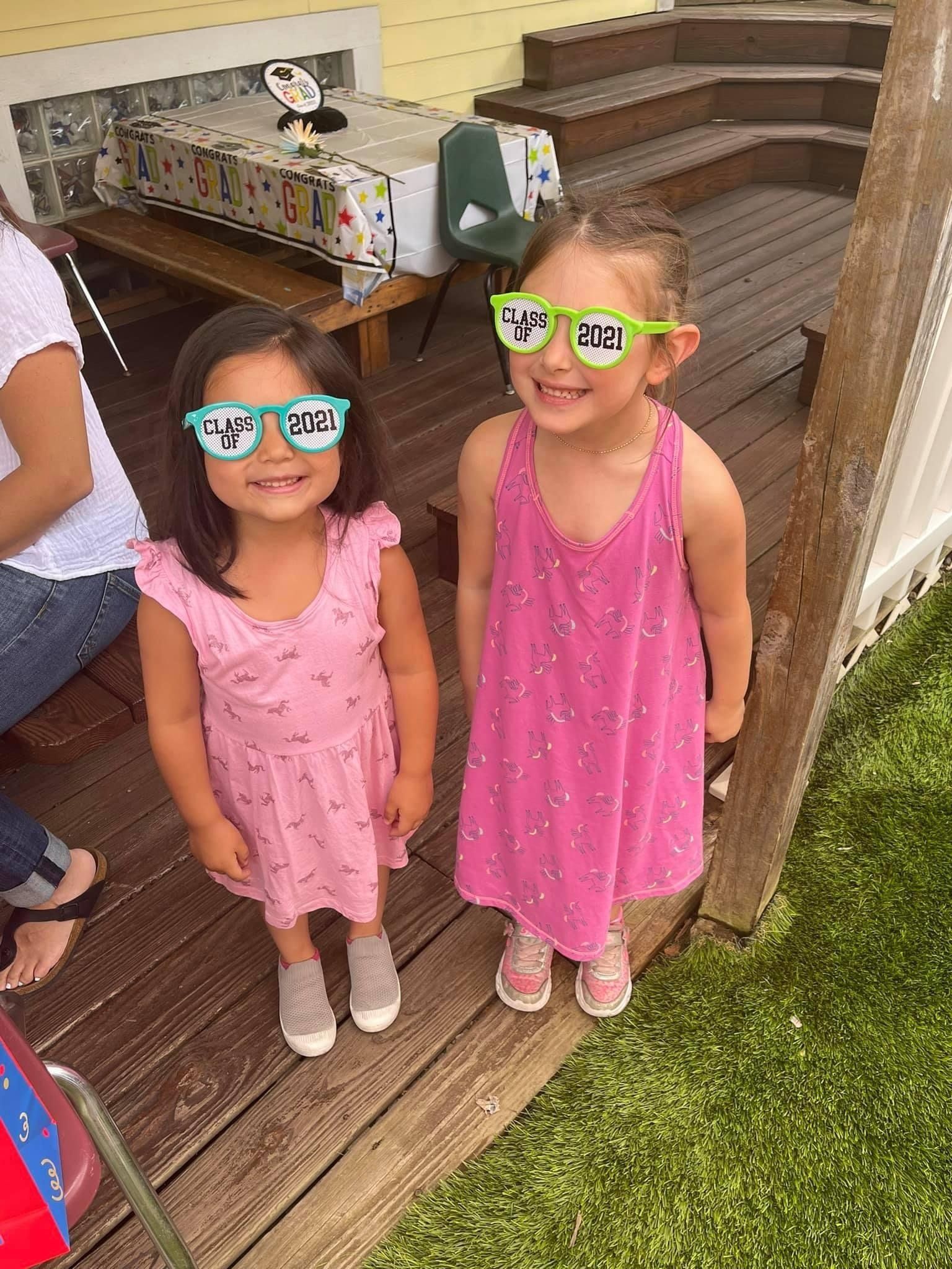 two young girls wearing fun glasses
