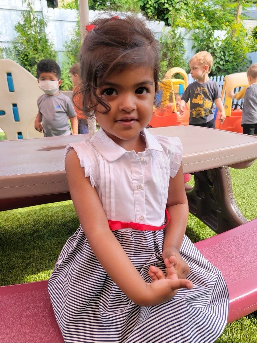 young girl sitting outside at recess
