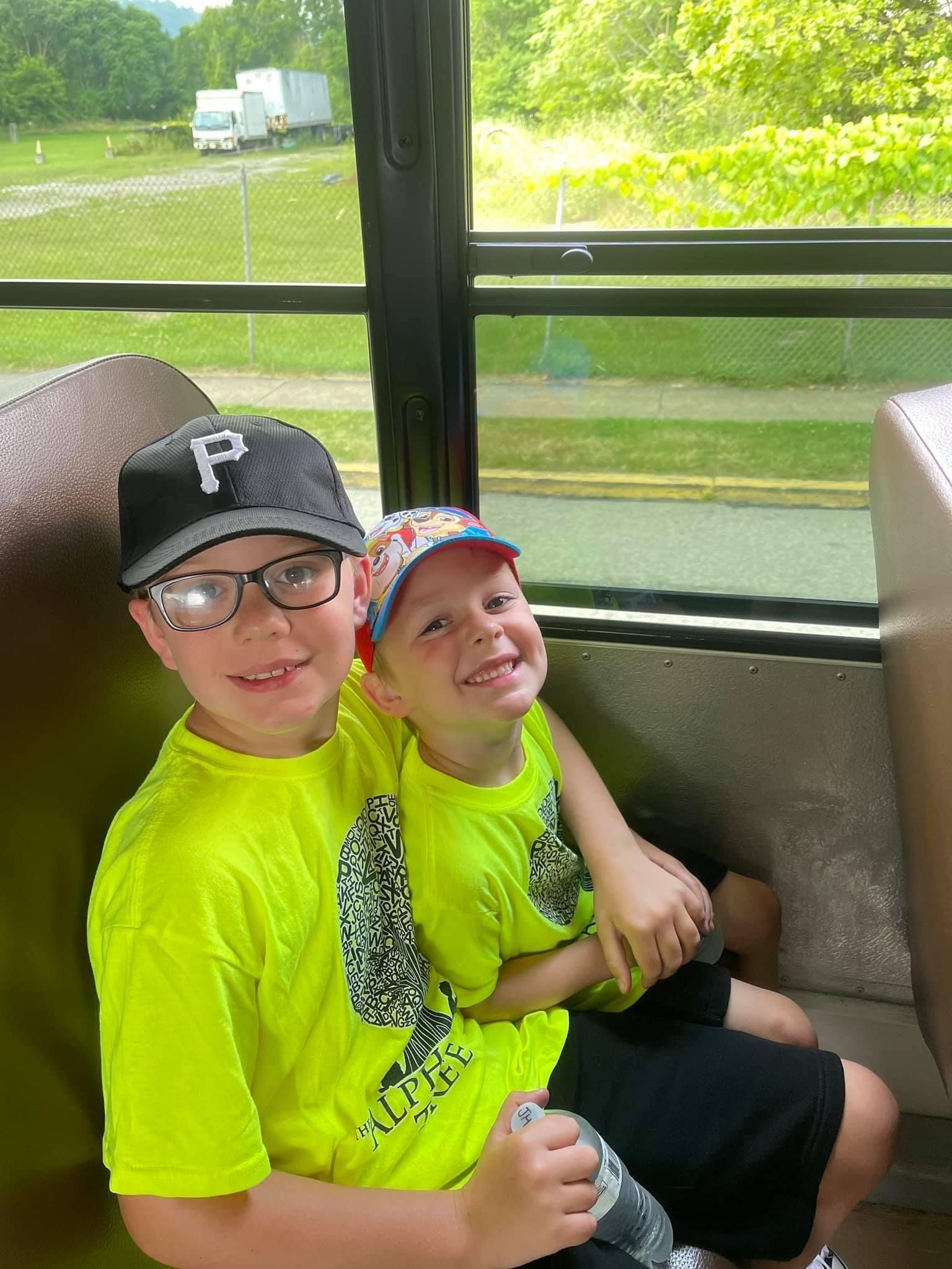 two young boys on the bus for a school trip