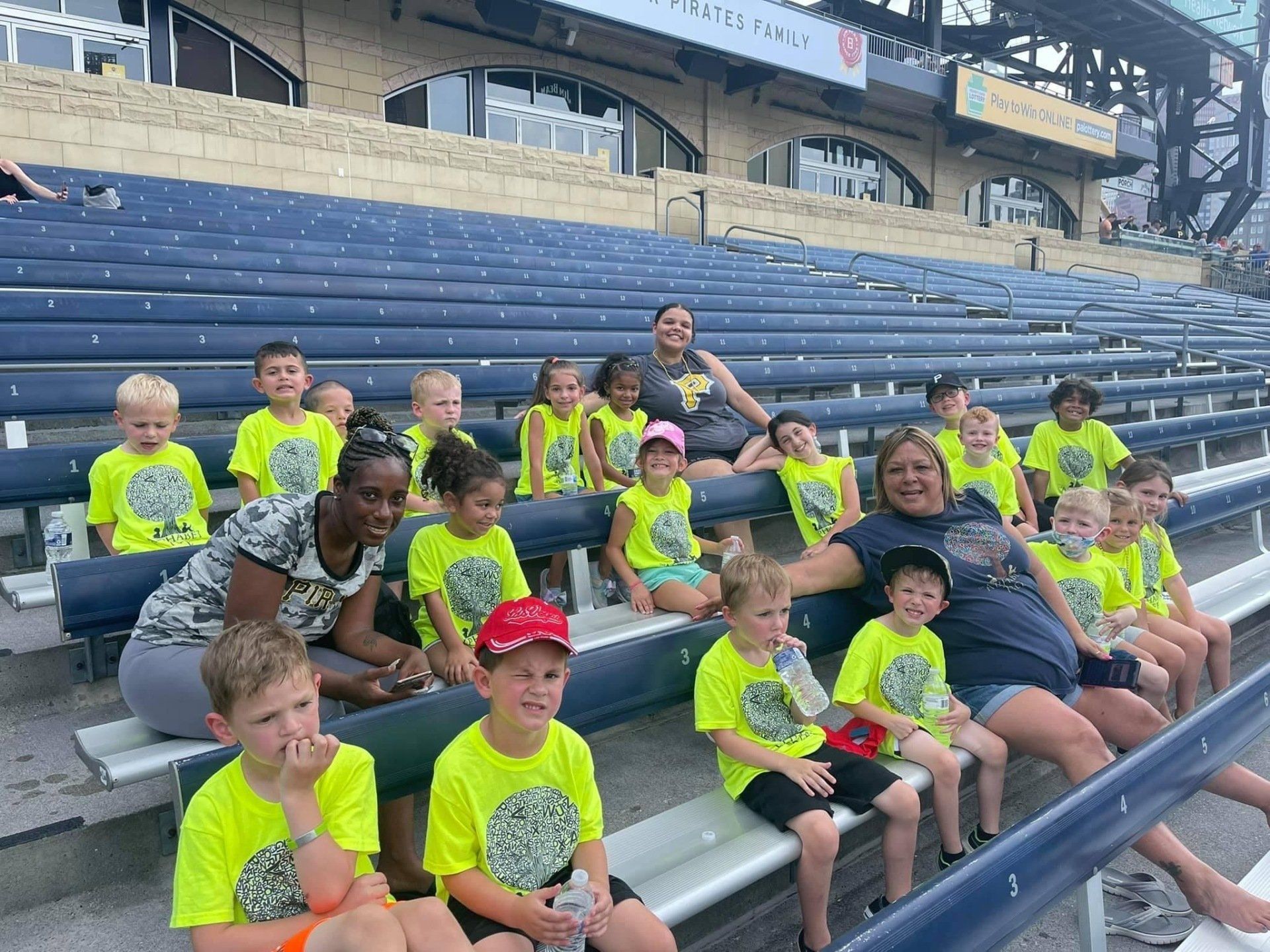 kids in the bleachers watching a pirates game