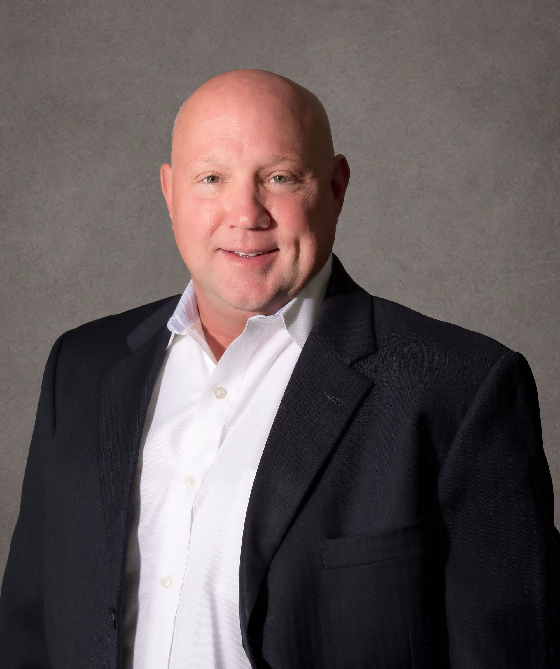 Professional headshot of Brian S. Demidovich, managing attorney at The Law Corner, wearing a suit in front of grey background