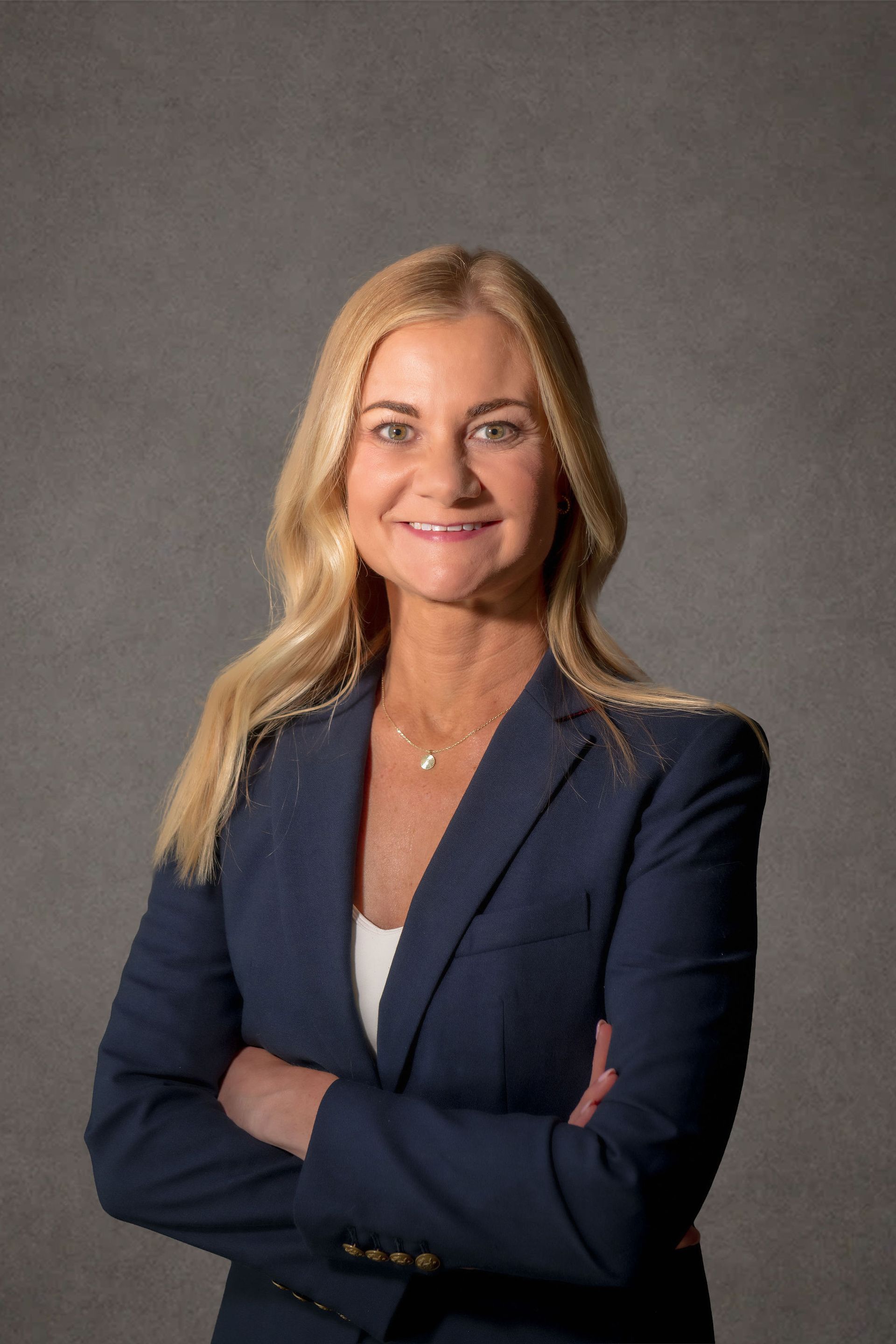 A professional headshot of Holly M. King, Senior Attorney, a woman wearing formal clothes in front of a grey background