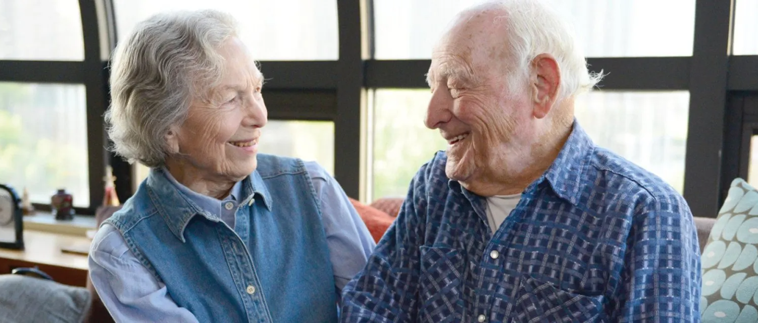 Elderly couple looking at each other and smiling