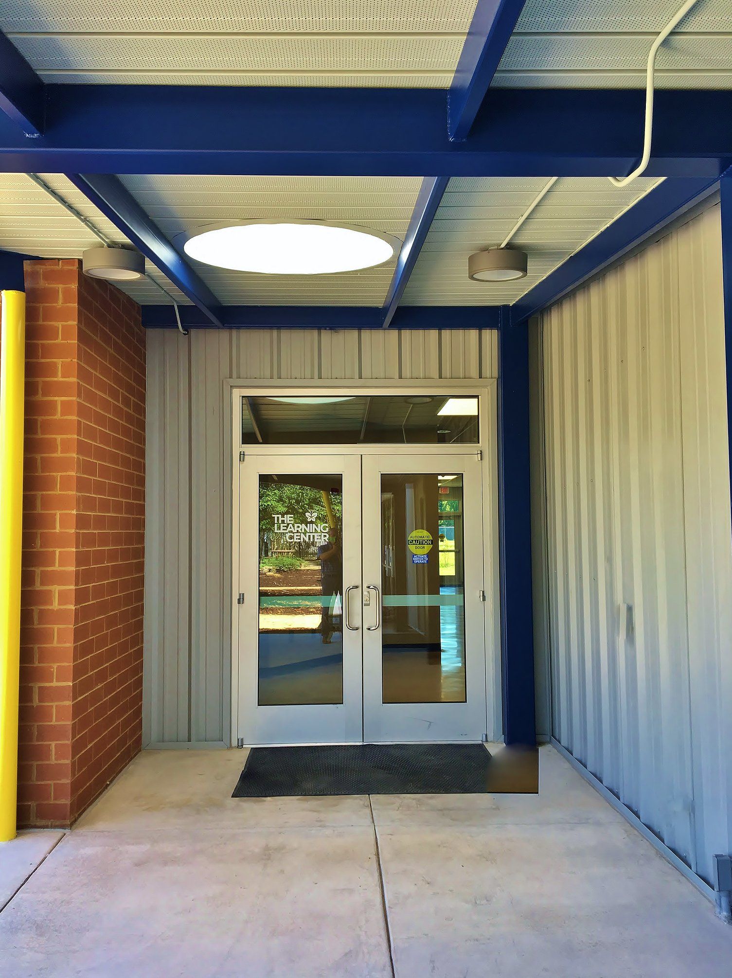 A building with a blue ceiling and a white door