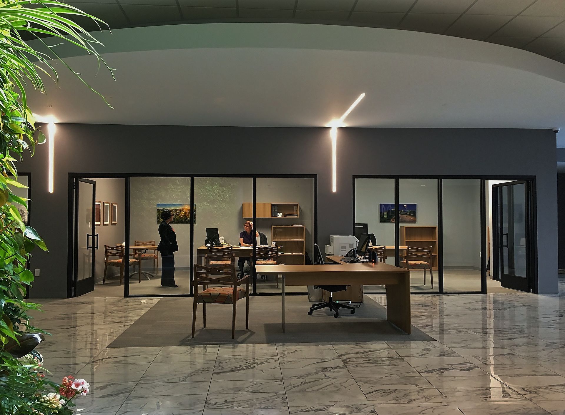 An artist 's impression of an office with a desk and chairs