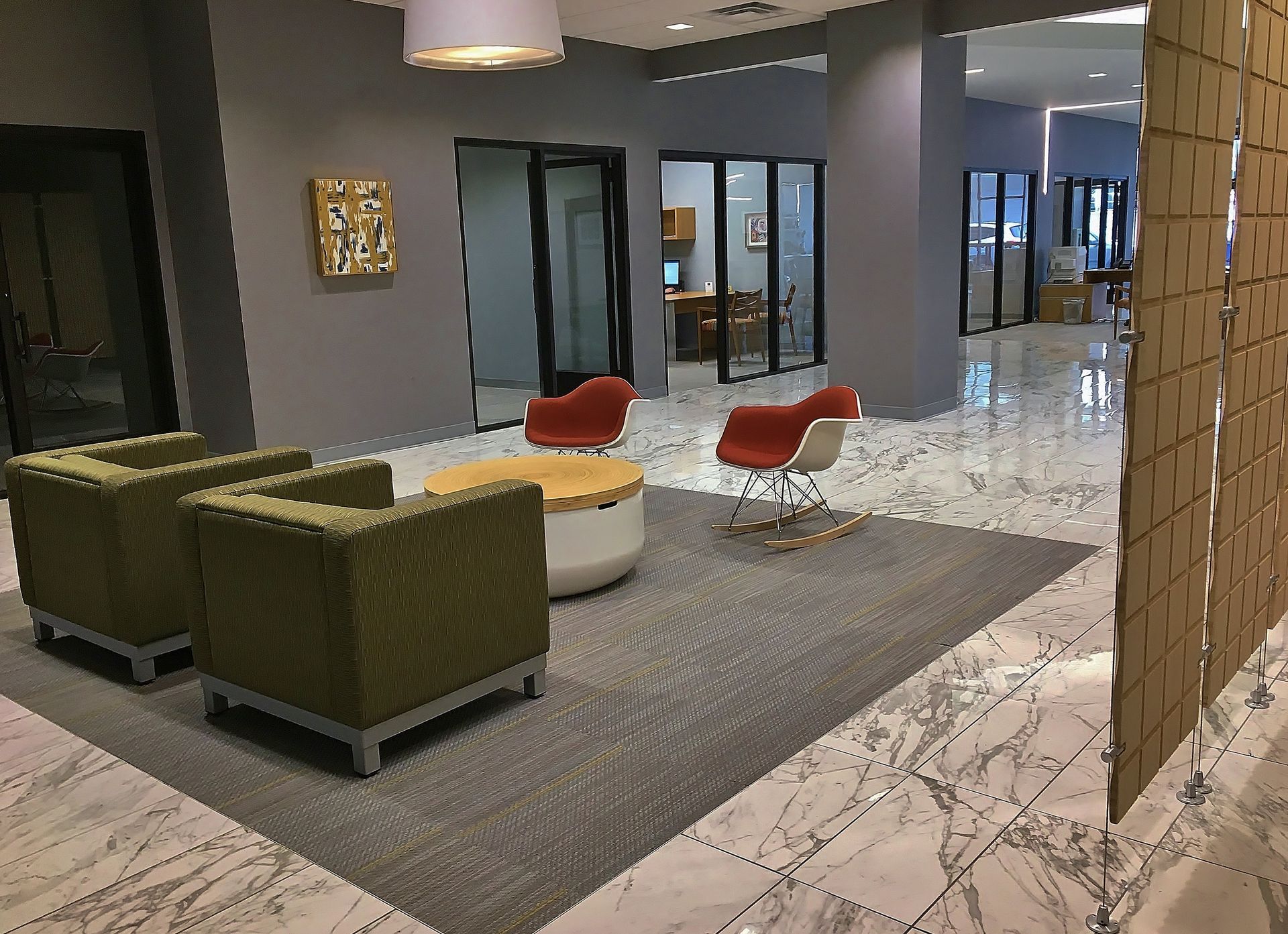 A lobby with chairs and a table in it