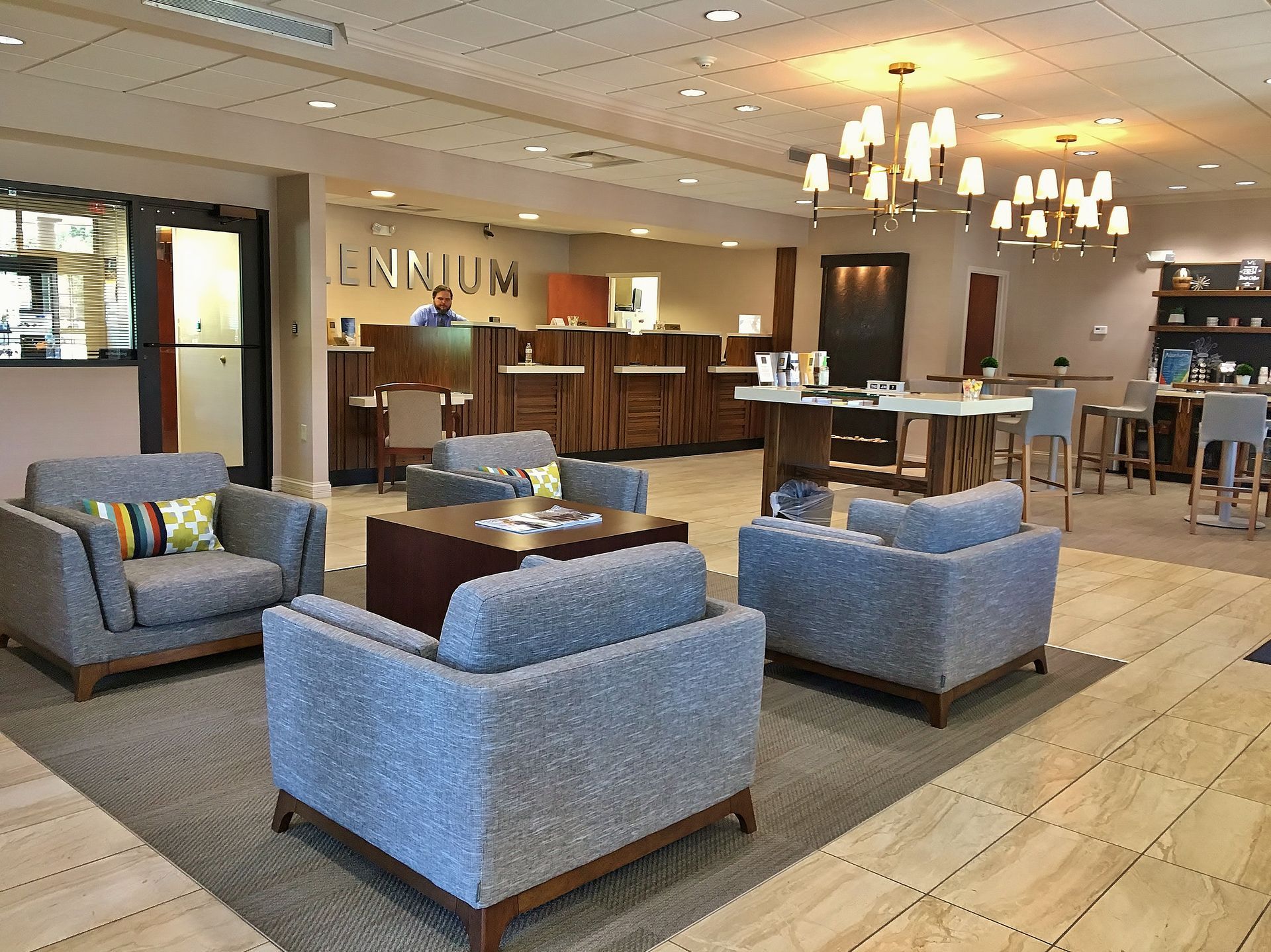 A hotel lobby with a lot of chairs and tables