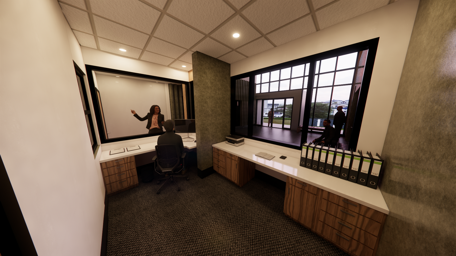 A woman is sitting at a desk in a room with a large window.