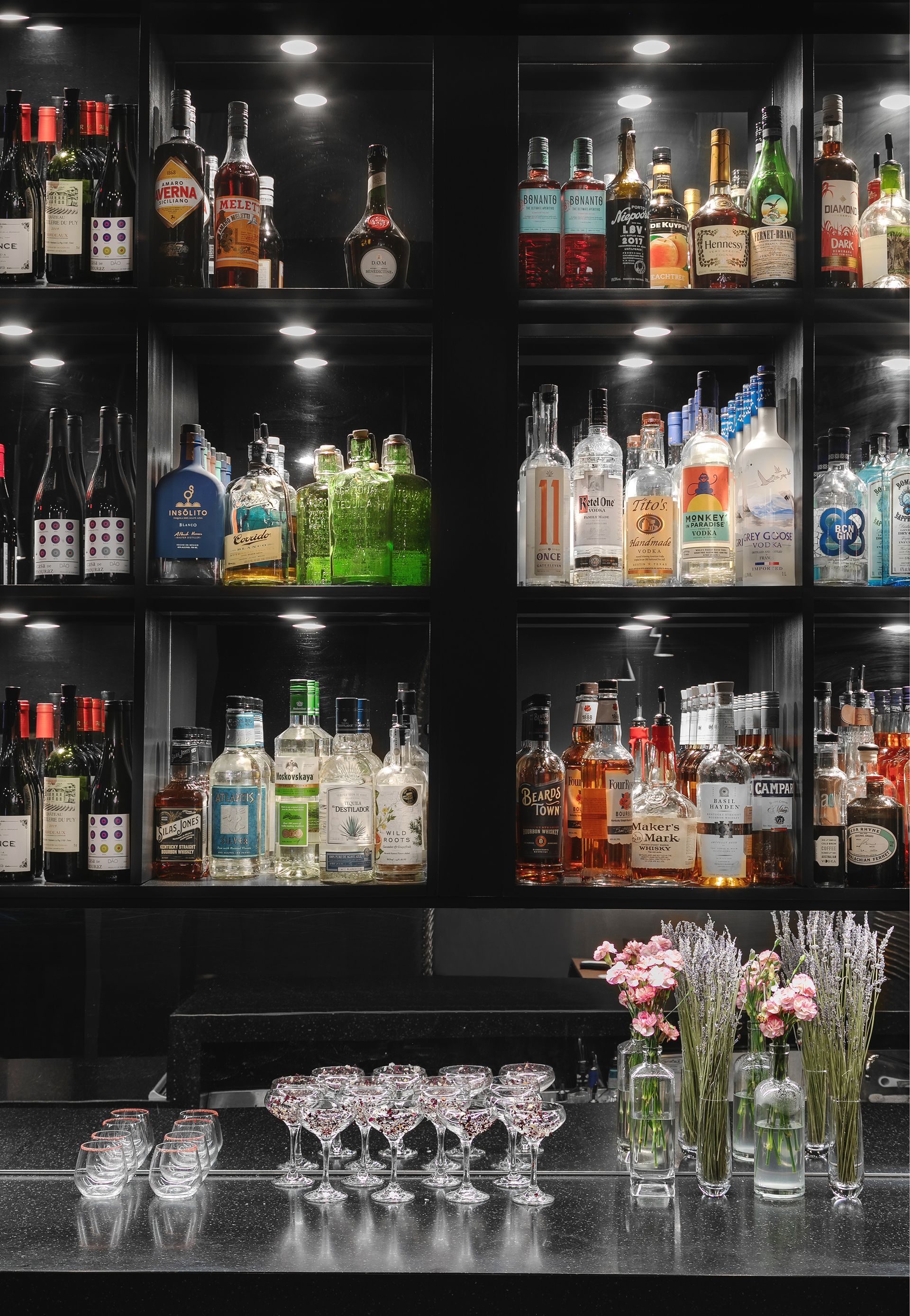 A bar filled with lots of bottles and glasses